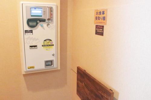 an atm machine in a room next to a wall at Pal Hotel Isahaya (Love Hotel) in Isahaya