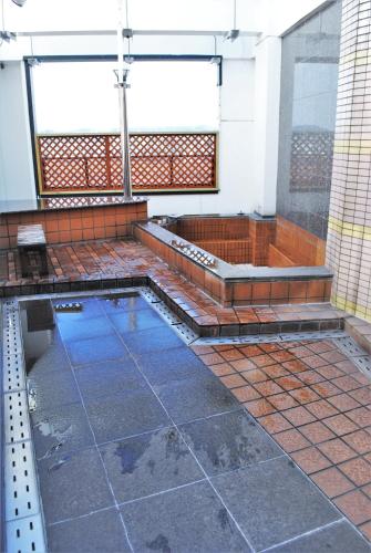 a swimming pool on top of a building at Pal Annex Furugou in Oita