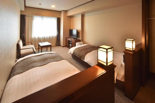 Ένα ή περισσότερα κρεβάτια σε δωμάτιο στο Dormy Inn Premium Otaru