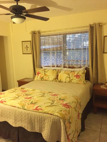 a bedroom with a large bed with a window at Sagusta Gardens NCA in NCA