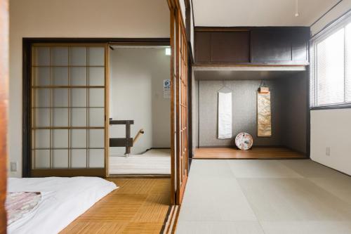a bedroom with a bunk bed and a door leading into a room at Yukiya in Osaka