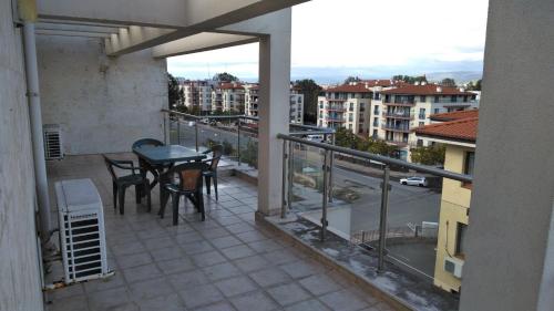 a balcony with a table and chairs and a view of a city at Darius HSTL in Sunny Beach
