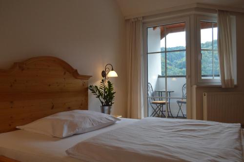 a bedroom with a white bed and a window at Pension Hinterleithner in Persenbeug