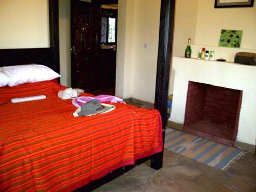 En eller flere senge i et værelse på Shwari Cottages