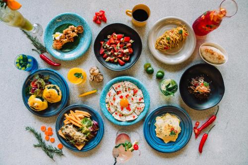 a group of plates of food on a table at Cara Cara Inn in Kuta