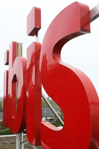 a large red msg sign in front of a building at ibis Charleville Mézières in Villers-Semeuse