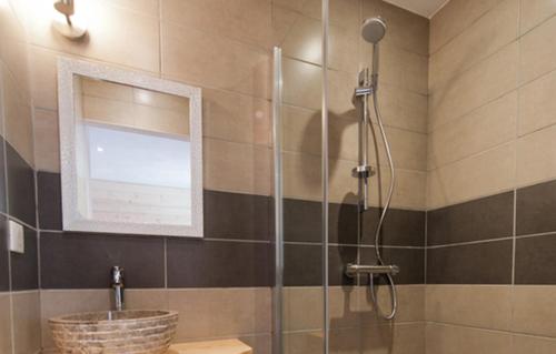 a bathroom with a shower and a sink at Odalys Chalet De Marie in Les Menuires