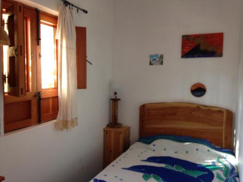 a small bedroom with a bed and a window at La Lampara in Stromboli