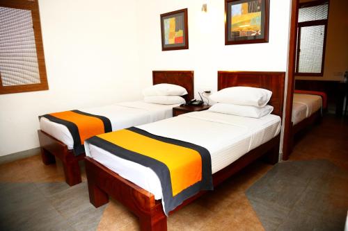 a room with three beds in a room at Spring Villas Kandy in Kandy