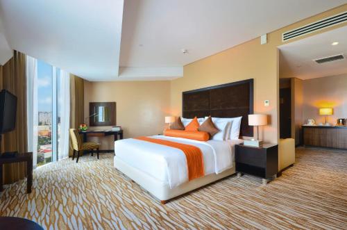 
a hotel room with two beds and a television at Acacia Hotel Manila - Multiple Use and Staycation Approved in Manila

