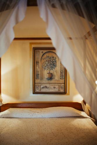 a bedroom with a bed with a picture on the wall at Casa Britona in Panaji