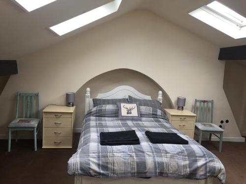 a bedroom with a bed and two night stands at 4c Belmont Terrace in Buxton