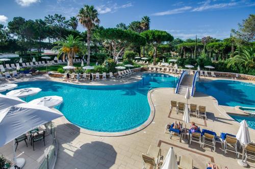 a pool with chairs and umbrellas at a resort at Four Seasons Country Club in Quinta do Lago