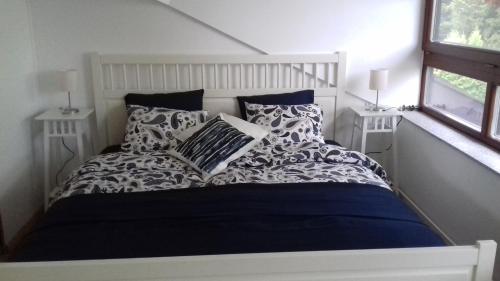a white bed with pillows in a bedroom at Ferienwohnung Wiesmühlstrasse in Henndorf am Wallersee