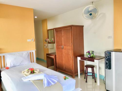 a bedroom with a bed and a desk and a cabinet at J Apartment in Ao Nang Beach