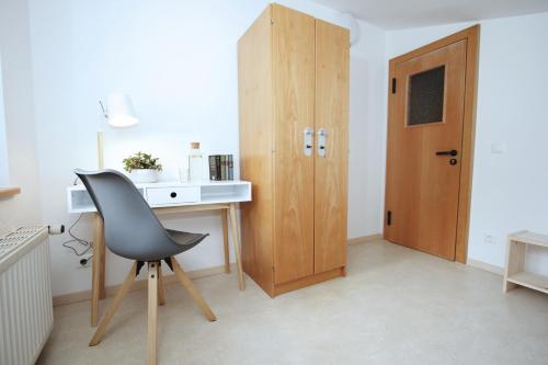 a room with a desk and a chair and a door at Berg Blick Jugendherberge mit Privatzimmer in Kochel