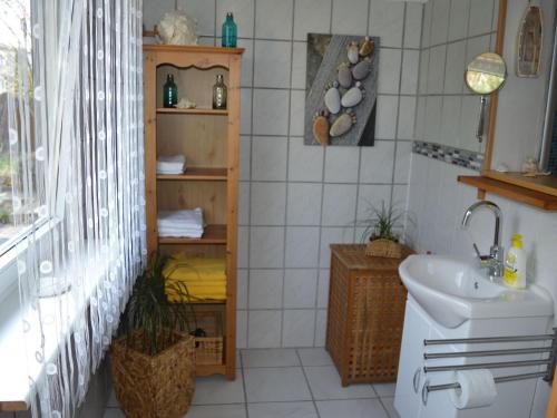 a bathroom with a sink and a toilet in it at Ferienhaus Ritzhaupt in Angelbachtal