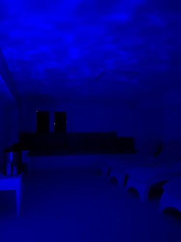 a blue room with a table and chairs at GFH - Hotel Sole Resort & Spa in Marotta