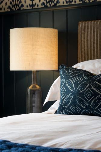 a bedroom with a bed with a lamp on it at The Cookie Jar in Alnwick