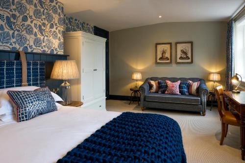a bedroom with a bed and a couch and a table at The Cookie Jar in Alnwick
