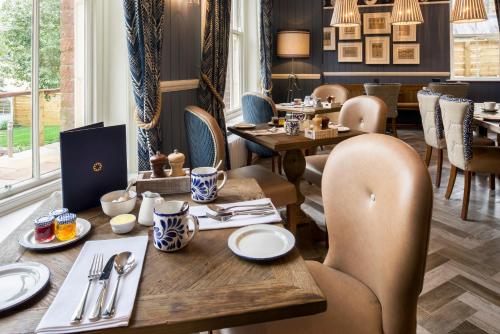 a restaurant with a wooden table and chairs and a table and chairsktop at The Cookie Jar in Alnwick