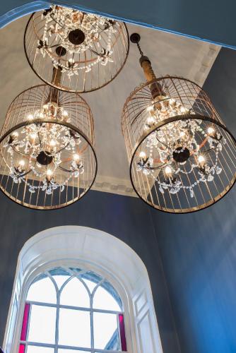 two chandeliers hanging from a ceiling with a window at The Cookie Jar in Alnwick