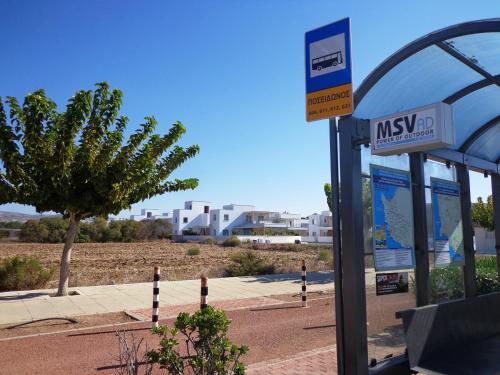 a bus stop with a sign at a gas station at Plage Residences in Paphos City