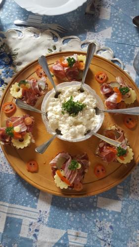 a plate of food on a table with dip at Farm stay Majdač in Solčava