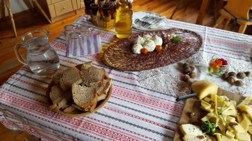 a table with two plates of bread and food on it at Farm stay Majdač in Solčava
