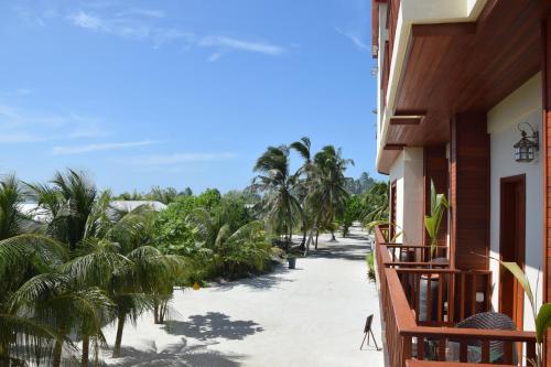 a balcony view of the beach from a house at Araamu Hotels Maldives at Dhiffushi in Dhiffushi