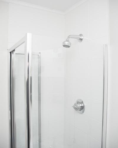 a shower with a glass door and a shower head at Bridgend Hotel in Bridgend