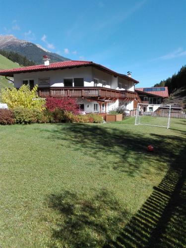 a large yard with a house in the background at Appartementhaus Gleirscher in Neustift im Stubaital