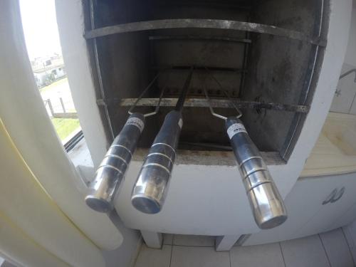 a group of pipes sticking out of a window at Pousada do Primo in Capão da Canoa
