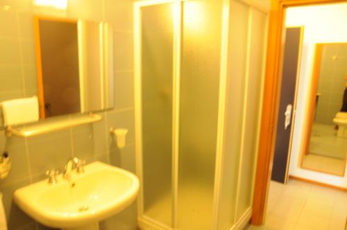 a bathroom with a sink and a shower at Hotel Eden in Orbassano