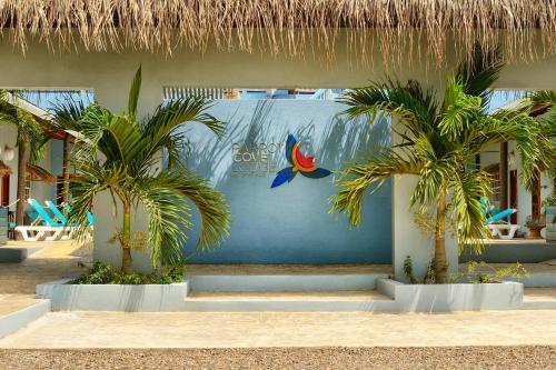 a resort with palm trees in front of a building at Parrot Cove Lodge in Hopkins