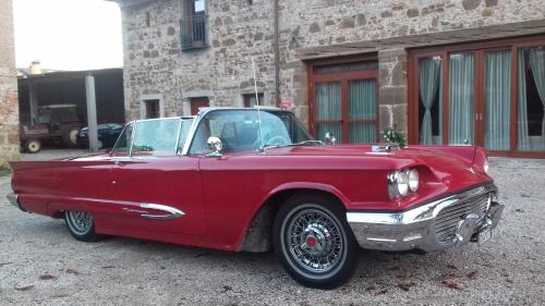 a red car parked in front of a building at Alloggio Agrituristico Conte Ottelio in Pradamano