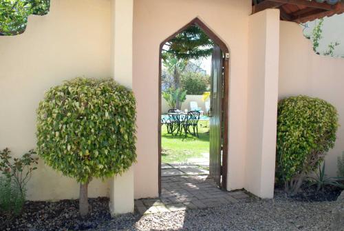 an entrance to a house with an open door at Mandalay Guest House Plettenberg Bay in Plettenberg Bay