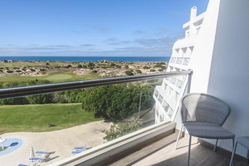 a balcony with a chair and a view of the ocean at MH Atlantico in Peniche
