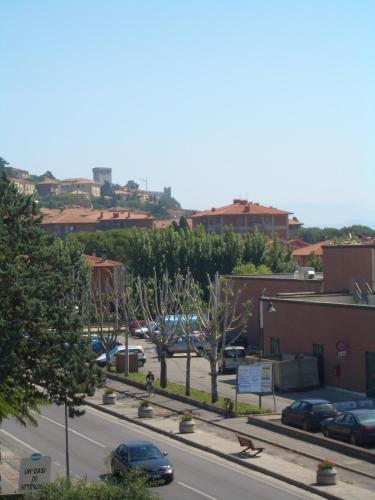 a city street with cars parked in a parking lot at Hotel Trasimeno Bittarelli in Castiglione del Lago