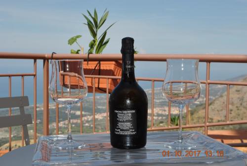 a bottle of wine and two wine glasses on a table at Bed & Breakfast StudioArcodia- in San Marco dʼAlunzio