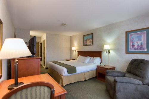 a hotel room with a bed and a couch at Vagabond Inn Executive in Green Valley