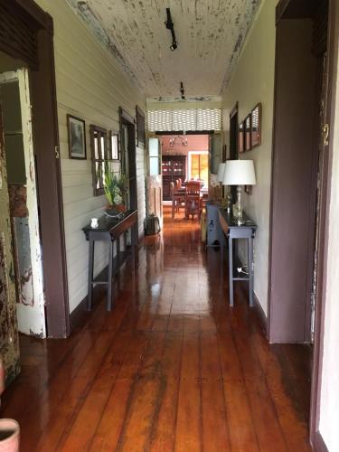 an empty hallway of a house with a hard wood floor at Hotel Hacienda El Rodeo in Rodeo