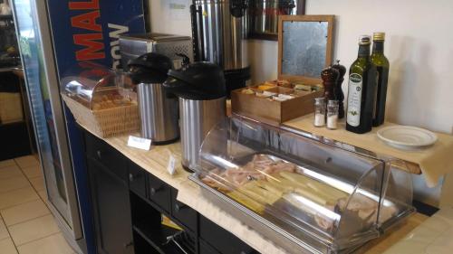 a counter with some food and bottles of wine at Hotel Il Lato Azzurro - Isola di Sant'Erasmo - NO VEHICLES ACCESS in Venice