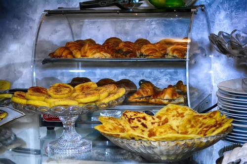 a display of pastries and breads in a bakery at Hotel Vents Des Iles in Essaouira