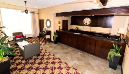 a hotel lobby with a reception desk and a clock at Howard Johnson by Wyndham Portsmouth in Portsmouth