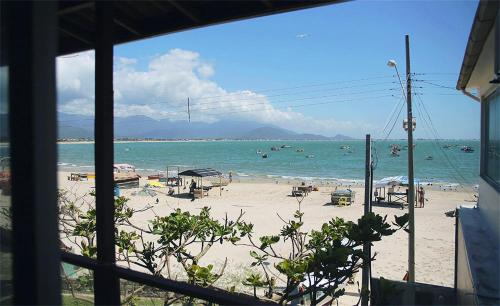 a view of a beach with people in the water at Pousada Louise in Pinheira