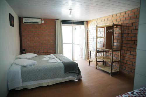 En eller flere senge i et værelse på Pousada do Francês