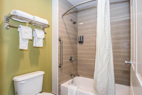 a bathroom with a shower with a toilet and a sink at Americas Best Value Inn Fort Worth in Fort Worth