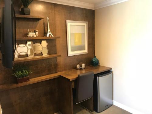 a room with a desk with a chair and a mirror at Stallion Motel Los Angeles in Los Angeles