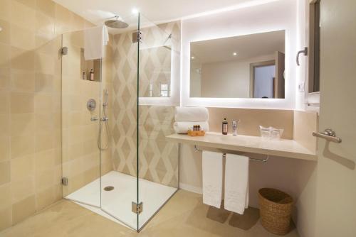 a bathroom with a shower and a sink and a mirror at Canavall in Palma de Mallorca